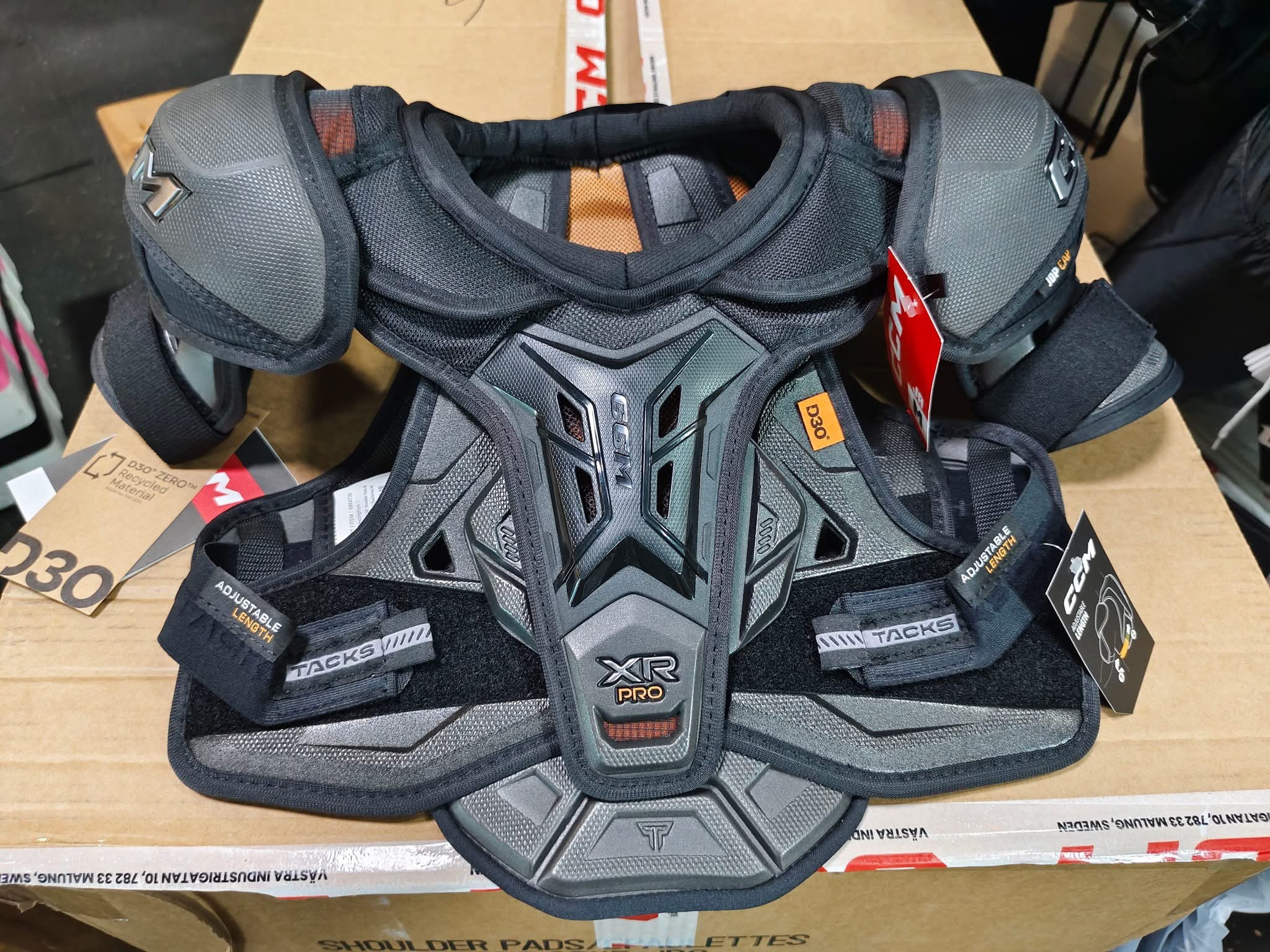 CCM Tacks XR Pro shoulder pads laid out for a fitting