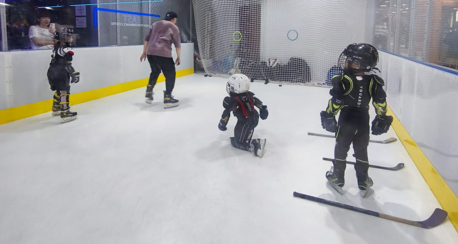 Young skaters training on the synthetic ice rink